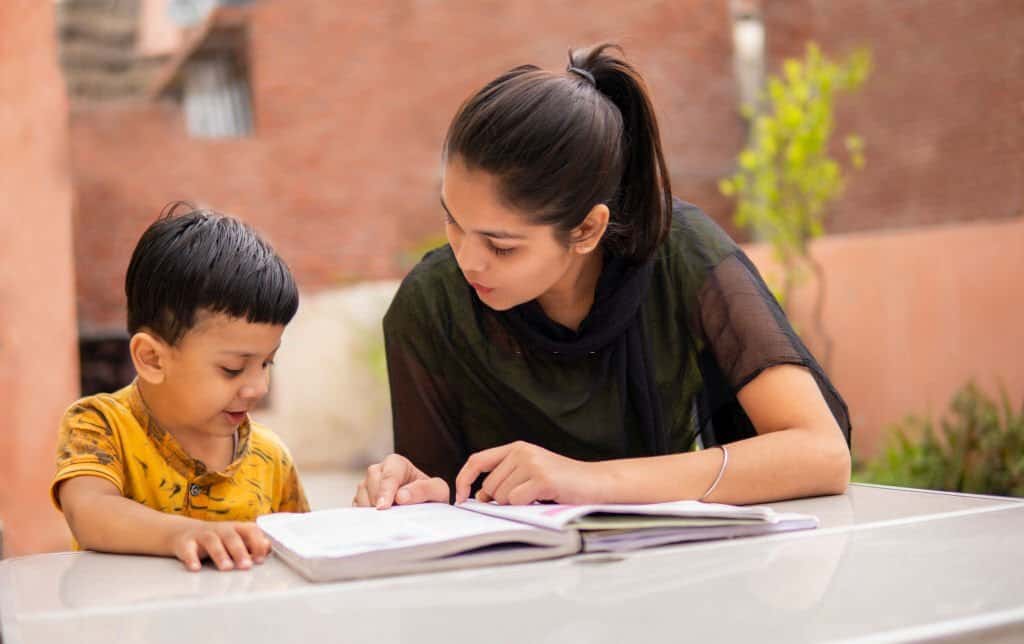 Home tutor helping a young student
