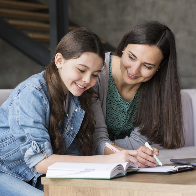 Tutor working with children in a study setting
